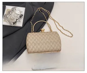 Macro view of champagne glitter clutch bag with metal handle and detachable chain strap