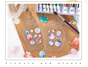 Close-up of decorative transparent watercolor bottle stickers for creative journaling