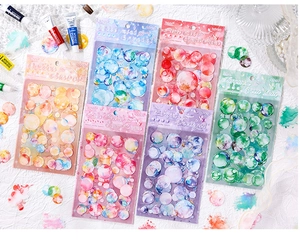 Detail of 40pcs watercolor PET stickers in six color sets on white textured background