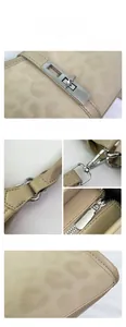 Detailed macro view of silver rectangular twist lock and smooth beige leather texture