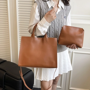 Brown leather tote bag set with matching pouch and adjustable strap for daily commute