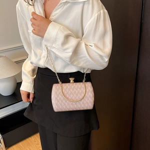 Elegant pale pink chain evening bag with textured finish and gold metal handle