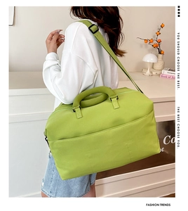 Detail of lime green travel bag featuring durable nylon fabric and adjustable shoulder strap