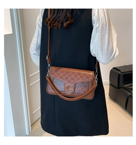 Brown crossbody bag with lattice texture, C-shaped metal buckle and woven handle details
