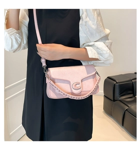 Detail of pink plaid texture shoulder bag featuring metallic C buckle and dual straps