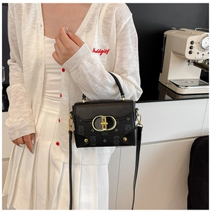 Detalle de cuero con patrón de lichi con herrajes dorados y textura de oso en el bolso