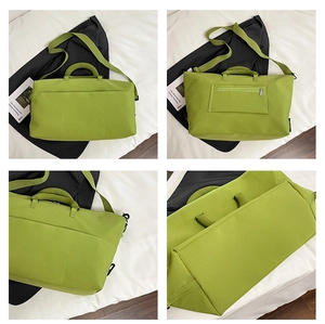 Macro details of green travel bag showing sturdy zippers, luggage sleeve, and shoulder strap