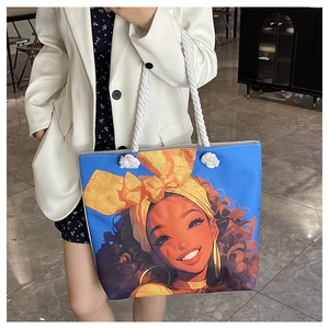 Blue tote bag featuring a stylized Black girl portrait print and white thick rope handles