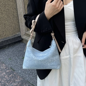 Blue denim hobo shoulder bag with sparkling silver accents and bow strap detail