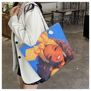 Fashion canvas tote bag with vibrant portrait print and nautical rope handles shown on shoulder