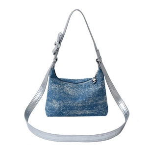 Denim crescent shoulder bag with a snowflake wash finish and a decorative bow strap