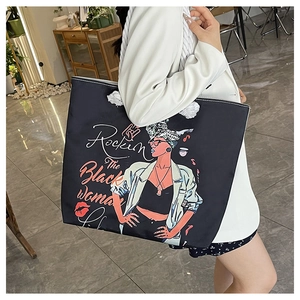 Detail of canvas tote bag with black girl print and sturdy white rope shoulder strap