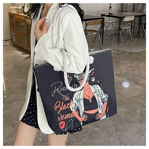 Detail of large canvas tote bag with bold black woman illustration and rope handles