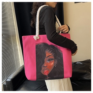 Detail of hot pink tote bag with thick rope handles and black girl love illustration