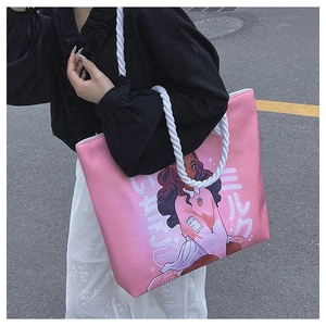 Detail of pink canvas tote bag with anime girl print and durable white rope handles