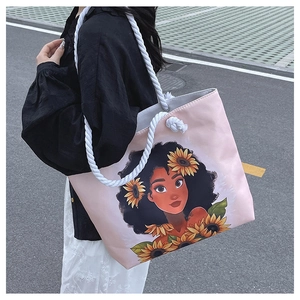 Detailed close-up of pink tote bag with thick cotton rope handle and sunflower girl print