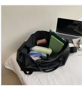 Internal view of spacious black travel bag showing storage for laptop and water bottle