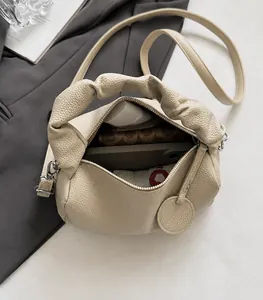 Interior view showing the spacious storage capacity of the beige soft leather Boston bag