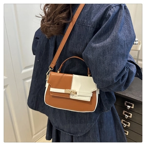 Detail of two-tone Kelly bag featuring vintage brown and beige PU leather with gold lock