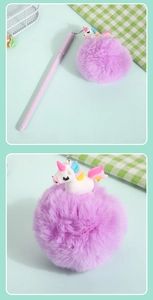 Detailed close-up of a white unicorn charm and large purple pompom on a ballpoint pen