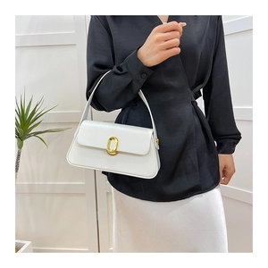 Minimalist white leather handbag with golden oval clasp shown in a modern fashion style
