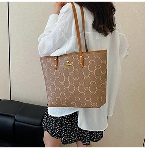 Detail shot of the large tote bag showing letter pattern and golden kangaroo logo