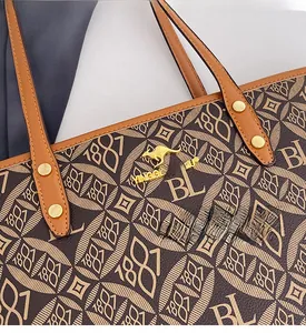 Detail of vintage tote bag with kangaroo logo, monogram print and golden metal hardware