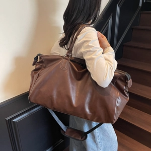 Large vintage dark brown leather travel bag with adjustable shoulder strap for men
