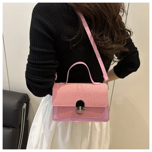 Detailed back view of pink leather and fabric crossbody bag with silver clasp lock