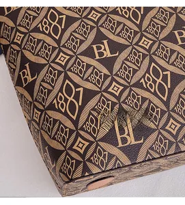 Detailed macro view of dark brown monogram printed tote bag with precision stitching