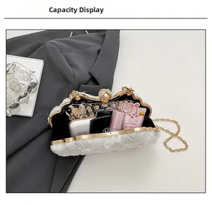 Lace flower evening bag detail showing interior capacity for cosmetics and accessories