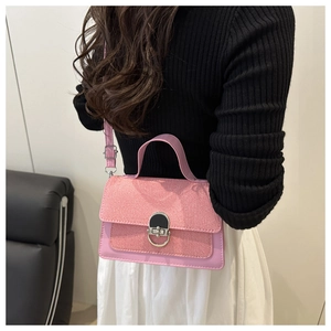 Detail of pink leather handbag with woven texture flap and silver metal ring buckle