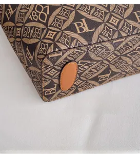 Close-up of the reinforced brown leather bottom with monogram pattern and durable stitching