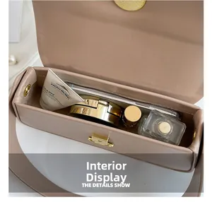 Internal view of beige leather bag showing storage capacity for phone and cosmetics