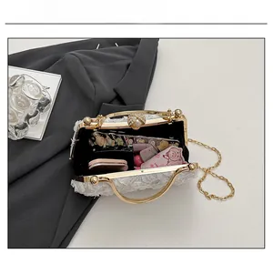 Internal view showing capacity for makeup and phone in white lace evening box bag