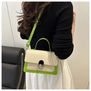 Detail of neon green and beige contrast crossbody bag showing its texture and strap