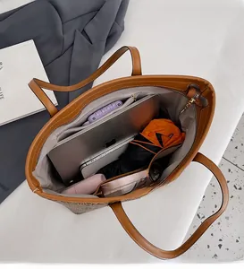 Top view of large brown leather tote bag interior showing spacious capacity for laptop