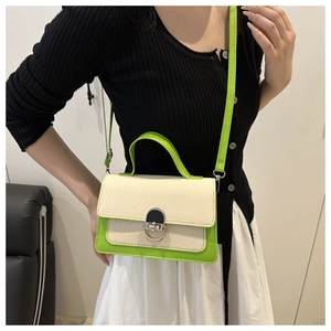 Detail of contrast stitch mini bag with neon green trim and silver swivel lock closure