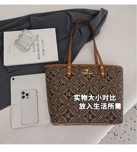 Flat lay showing high-capacity printed tote bag size with iPad and daily essentials