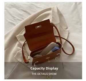 Detailed capacity view of a color-block leather crossbody bag holding daily essentials