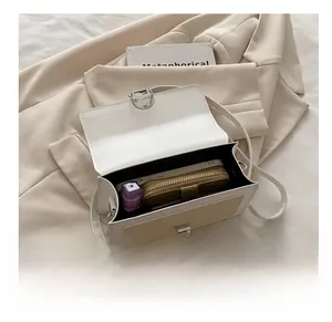 Interior view showing capacity for phone and wallet in a contrast flap crossbody bag