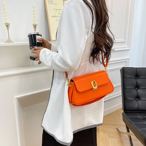 Vibrant orange rectangle crossbody bag with gold oval twist lock and matte leather finish