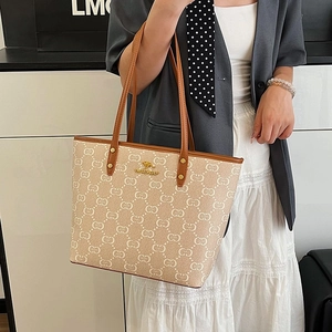 Chic beige monogram tote bag with kangaroo logo and brown leather handles for women
