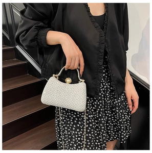 Exquisite pearl white clutch bag with a golden metal handle and beaded clasp details