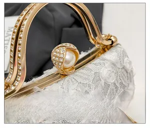 Macro detail of elegant lace evening clutch with pearl and rhinestone clasp