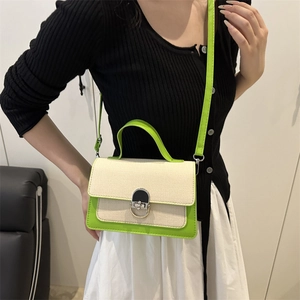 Chic cream canvas crossbody bag with neon green leather trim and silver metal lock