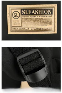Close-up of adjustable strap buckle and decorative logo patch on black backpack