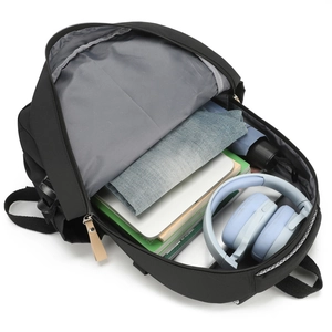 Minimalist black travel backpack showing large capacity with laptop and clothes storage