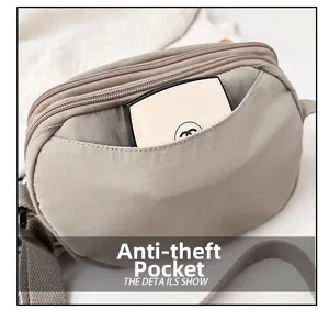 Detail view of khaki nylon crossbody bag featuring a hidden anti-theft zipper pocket
