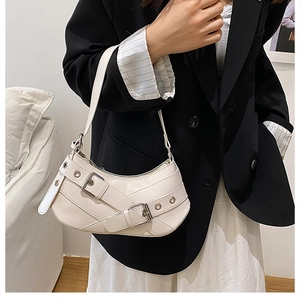 Chic off-white crescent underarm bag with retro buckle belts and metallic eyelets details
